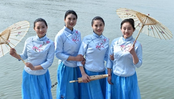 Service staff present workwear at fashion show in E China's ancient town